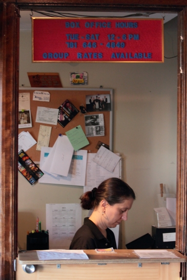 A woman tends to business in the Regent Theatre box office. June 16, 2012.