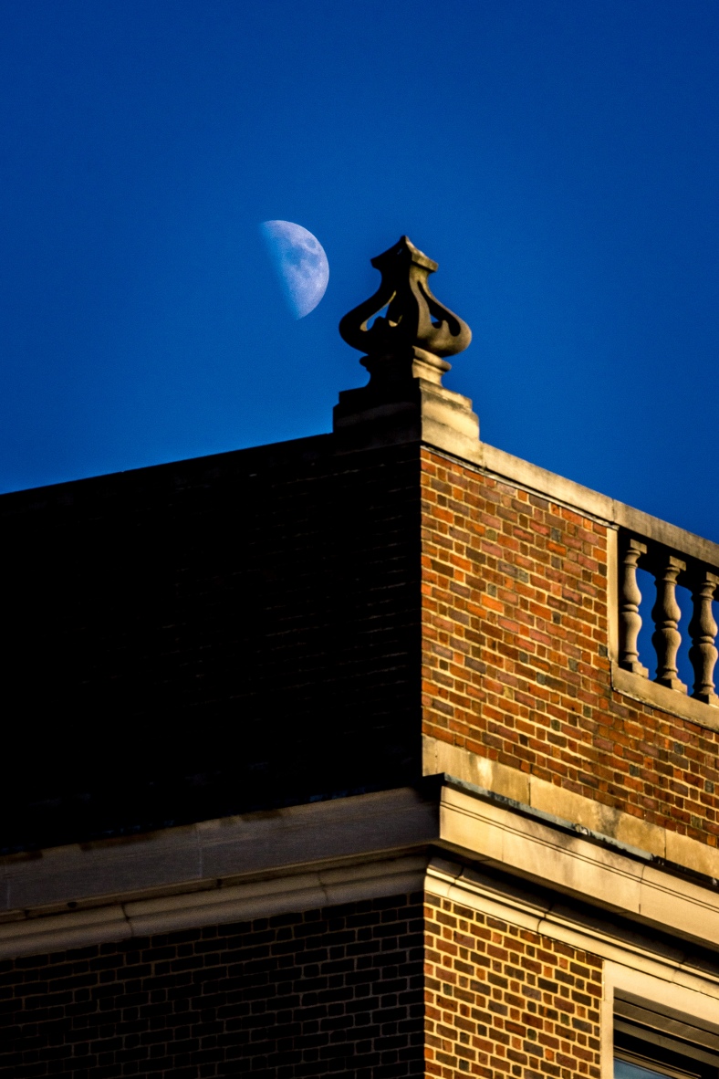 A waxing half moon seen next to an architectural ornament on the St. Agnes school in Arlington Center. November 29, 2014.