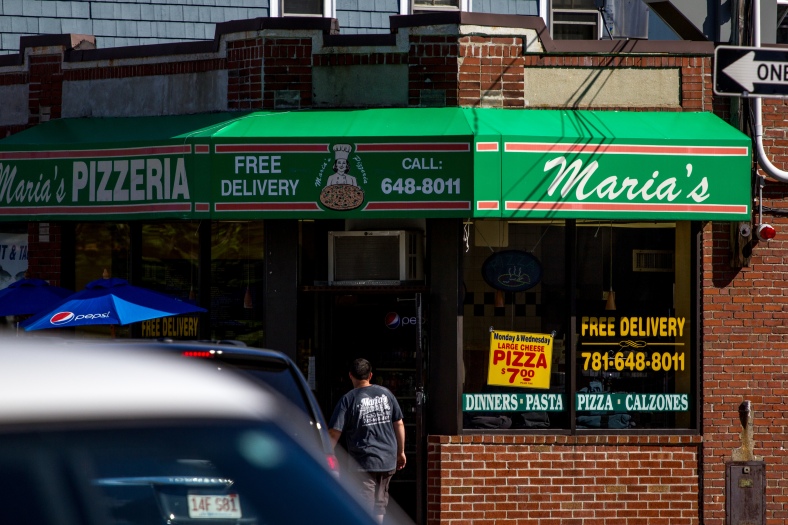An employee walks into Maria's Pizzeria on Massachusetts in East Arlington. June 20, 2014.