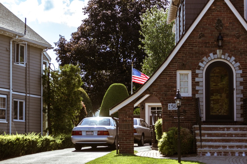 A home, complete with flagpole and American flag, along Mystic Street. August 05, 2015.